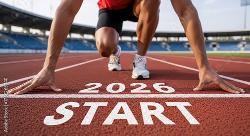 Athlete in starting position on a running track at the 