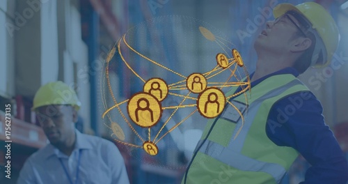 Displaying globe hovering between helmeted workers wearing safety vests in warehouse, with pallets