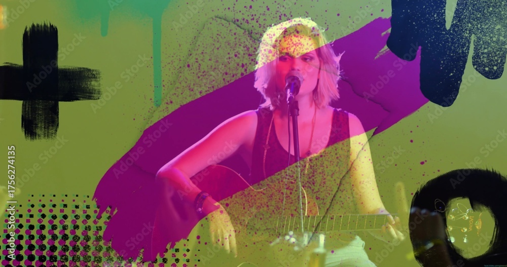 Fototapeta premium Performing musician strumming guitar and singing with microphone on stage, with abstract splatters