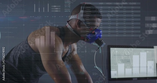 Leaning athlete wearing mask grasping handlebars pedaling in lab with monitor overlays, copy space