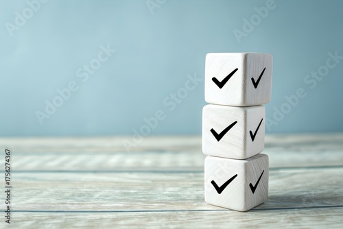 Stack of white cubes with checkmarks on a wooden surface