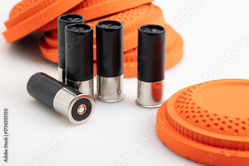Black shotgun shell and clay pigeon target on white background , Gun shooting game