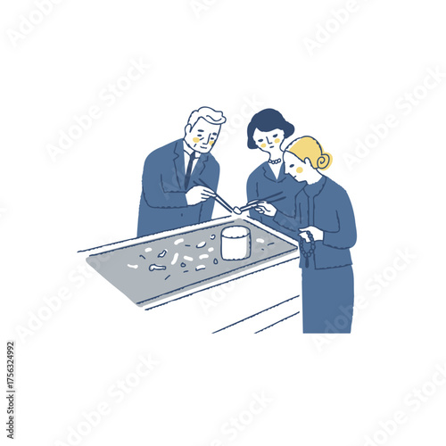 火葬後に骨上げをしている遺族