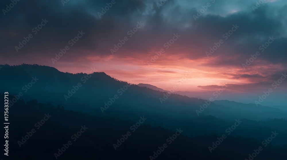 Fototapeta premium Dramatic mountainous landscape at dusk with vibrant orange and pink hues painting the sky