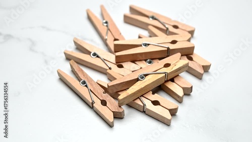 wooden clothes pegs rotating on white surface
