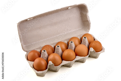 A dozen brown eggs sit snugly inside a recycled cardboard egg carton, isolated on white background.