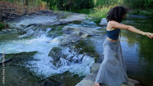A Serene Dance by the River: A Captivating Journey of Movement and Harmony Amidst Nature's Splendor in Tranquil Waters