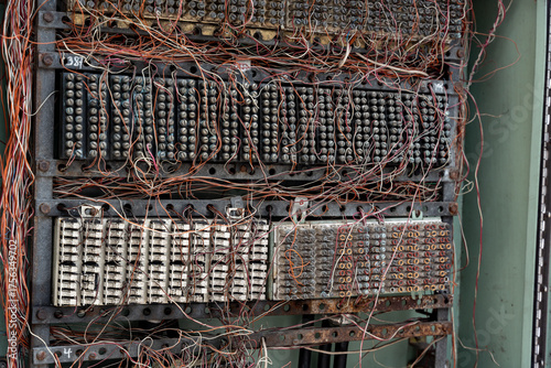 Close up of an old telephone exchange or switchboard, showing a complex connection block and a dense tangle of cables. This electromechanical switching system connected phone lines.