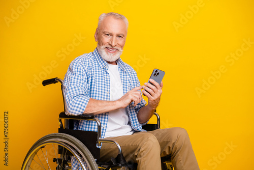 Photos Grandpa on wheels enjoys a sunny selfie moment using a smartphone with a bright