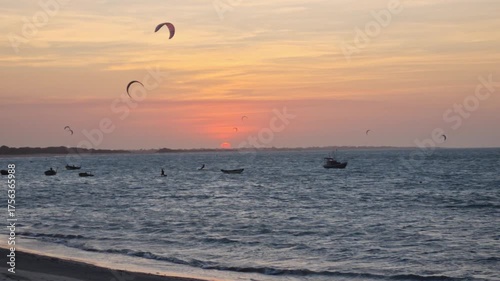 Stunning sunset at Barra Grande Beach, Piauí. Kitesurfers, boats, colorful sky, and tranquil ocean set a tropical scene that captures the spirit of adventure and relaxation in Brazil.