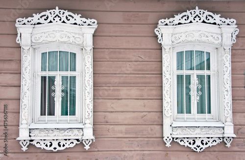 Two windows with antique shutters in a Russian city