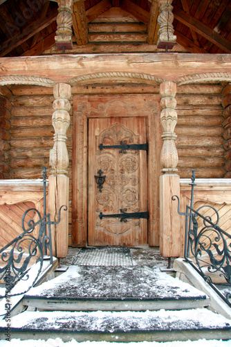 Log house entrance with wooden columns