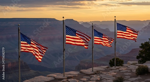 American flags waving proudly at the Grand Canyon overlook during a vibrant sunset, symbolizing patriotism and national pride in a breathtaking landscape.