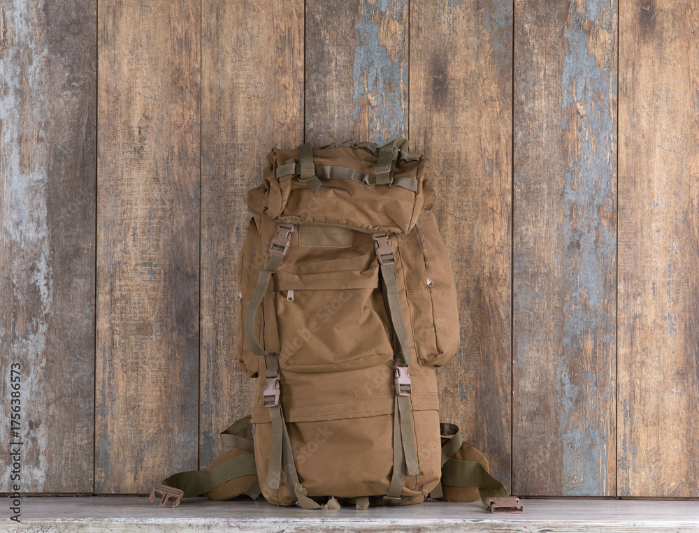 Fototapeta premium canvas travel backpack and accessories on a wooden table