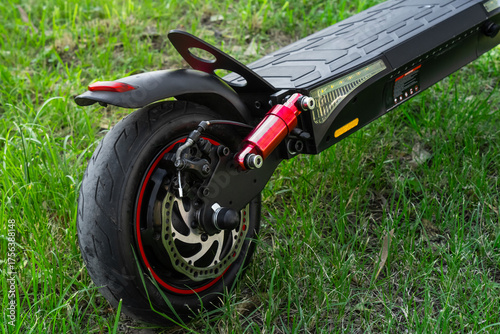 Electric scooter rear wheel with disc brake and suspension close-up, electric scooter concept