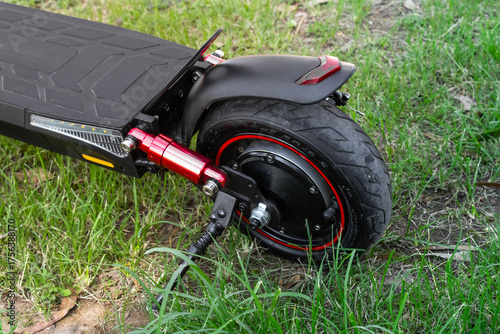 Electric scooter rear wheel with red suspension and LED reflector, electric scooter concept