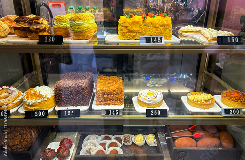 Delightful showcase of assorted cakes, pastries and bakery in bakery shop, showcasing variety of gourmet desserts and sweet treats