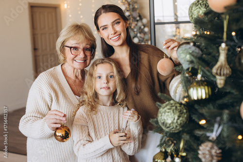 Three Generations Decorating Christmas Tree at Home