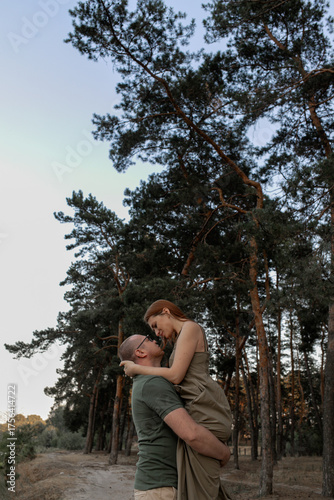 a loving look of a couple in a pine forest