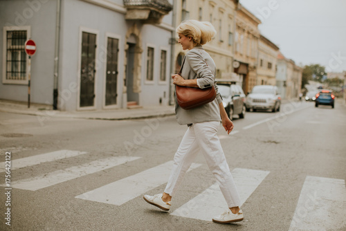 Woman crossing the street i...