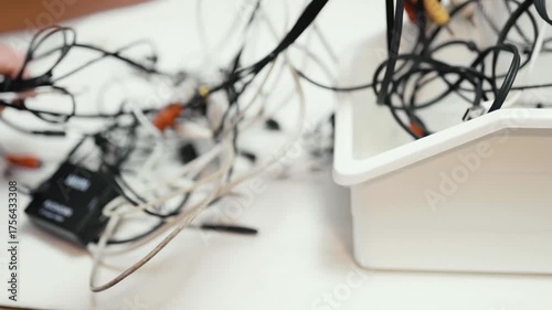 Tangled cords and cables on a table.
