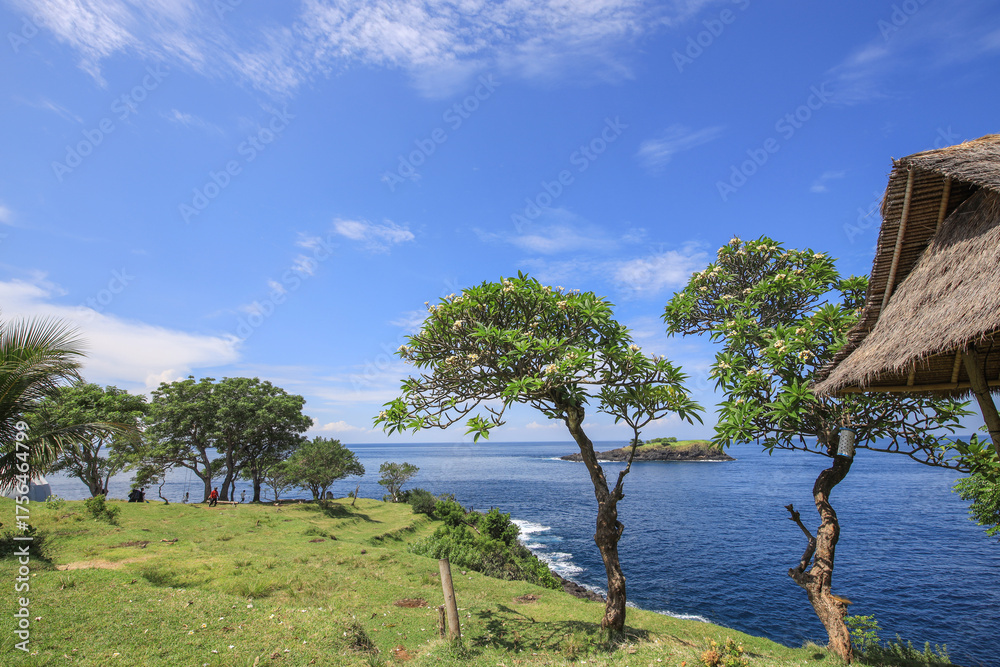 Fototapeta premium Beautiful blue ocean with a small island in the distance