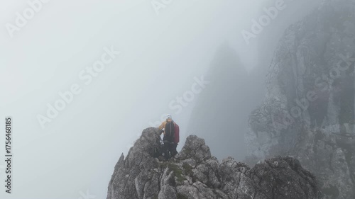 Mountaineers reaching a foggy rocky summit, Dachstein, Austria