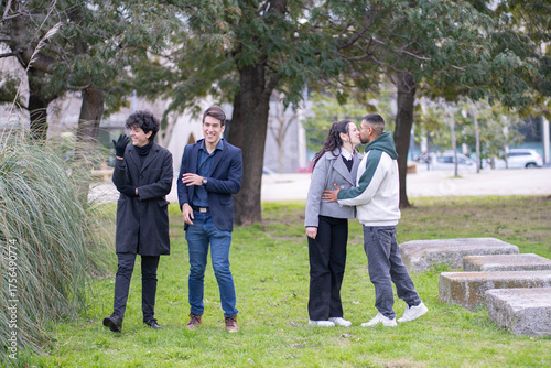 Multicultural young adults expressing friendship and romantic love outdoors