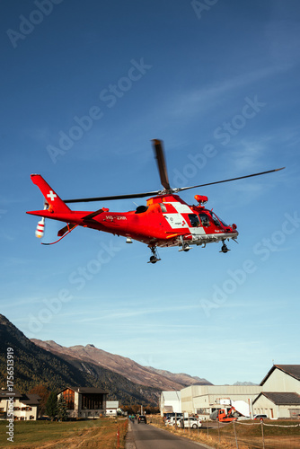Swiss Rescue Helicopter Flying Over Alpine Mountains