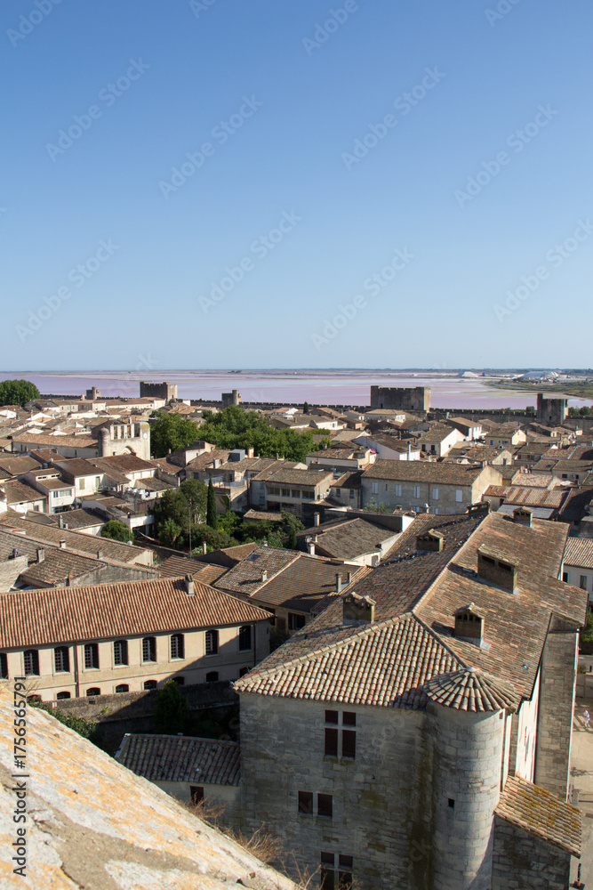 Obraz premium View of the ramparts, salt marshes, and medieval town of Aigues-Mortes from the Constance Tower in Aigues-Mortes Camargue France