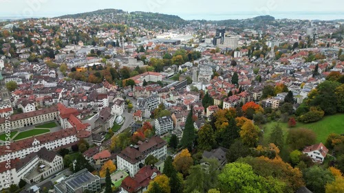 4k Drone Aerial Footage of saint gallen city in switzerland with autumn leaves and cloudy sky and the cathedral. High quality 4k footage