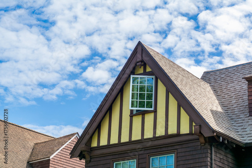 Photography Traditional Tudor-style family home with steep gable roof and decorative trim in