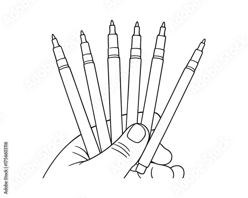 Hand holding a set of black thin marker pens, art supplies, sketching equipment.