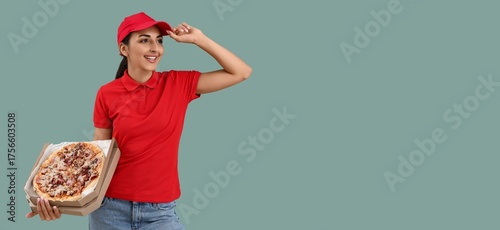 Female courier holding pizz...