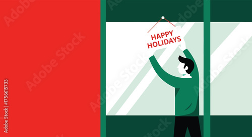 Man in green sweater hanging happy holidays sign on window of shop during the christmas season, spreading cheer and festive spirit.