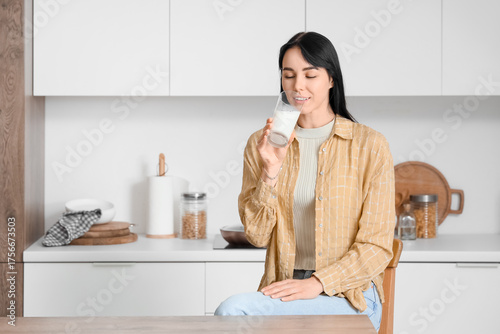 Young woman drinking milk i...