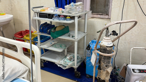 emergency medical equipment with oxygen tank and ventilator accessories at intensive care unit