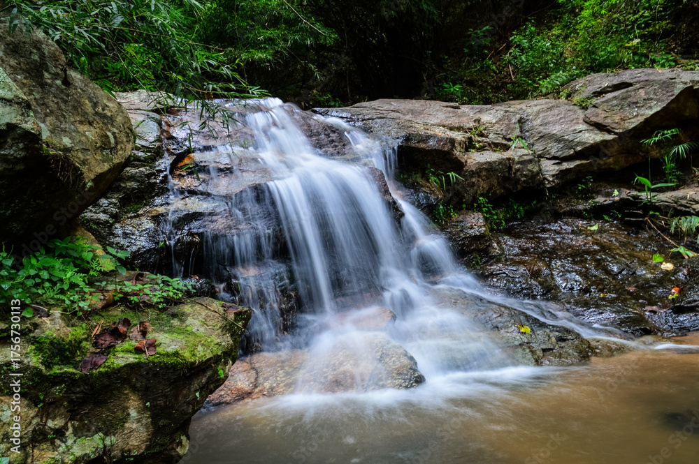 Fototapeta premium Beautiful Small Waterfall in Green Forest in jungle at Huay U-Mong Nature Trail Chiang Mai, Northern Thailand