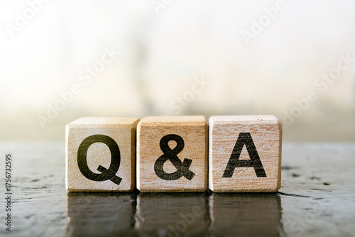 Wooden blocks with letters Q and A representing a question and answer
