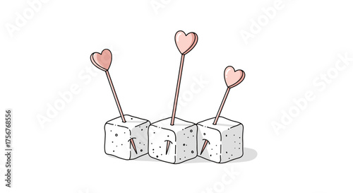 Three sugar cubes adorned with heart shaped toppers on sticks.