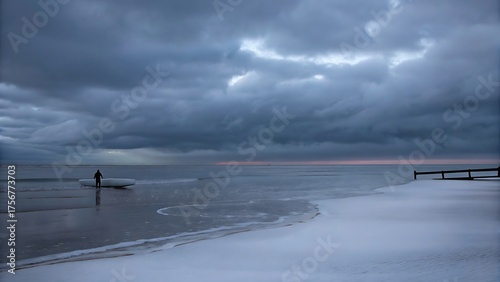Fototapeta Naklejka Na Ścianę i Meble -  A lone paddleboarder braves the icy waters of the baltic sea on a cold winter day, as dark storm clouds gather overhead, creating a dramatic seascape
