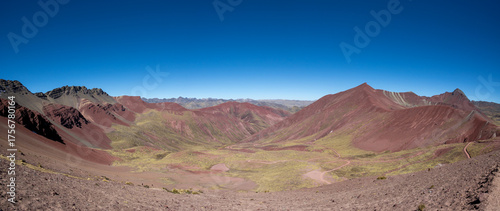 A valley surrounded by colorful mountains near Cusco Peru