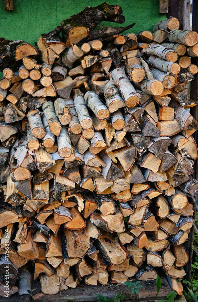 Fototapeta premium A stack of firewood in a woodshed outside