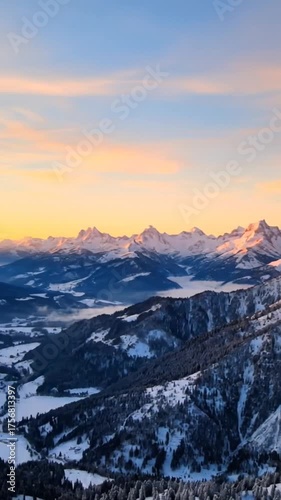 Snow capped mountains against a colorful sky during sunset