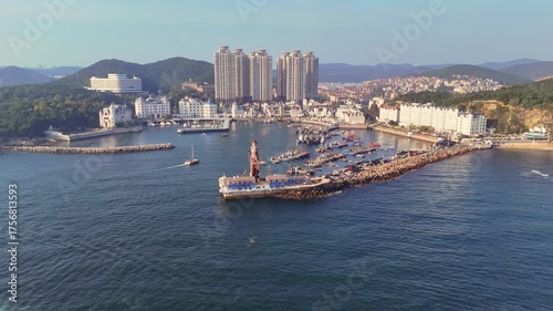 Orbit view of Dalian's fisherman wharf with mountains and city in the background