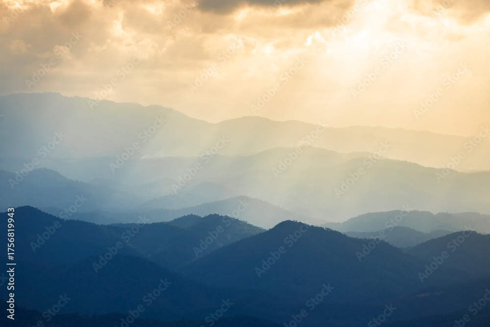 Fototapeta premium Landscape of Morning Mist with Mountain Layer. mountain ridge and clouds in rural jungle bush forest