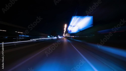 Driving Through a Futuristic Illuminated Street at High Speed. Experiencing a Fast-Paced Journey Through a Modern City with Bright Green and Blue Lights.