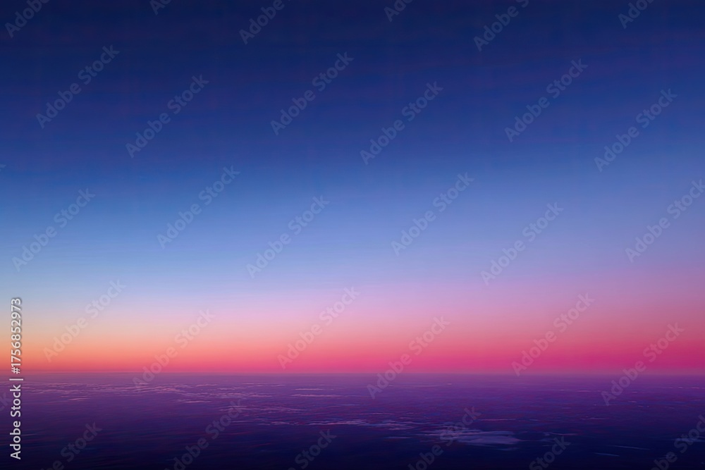 Fototapeta premium A vertical image captures a vibrant gradient sky transitioning from dark blue to pink and purple