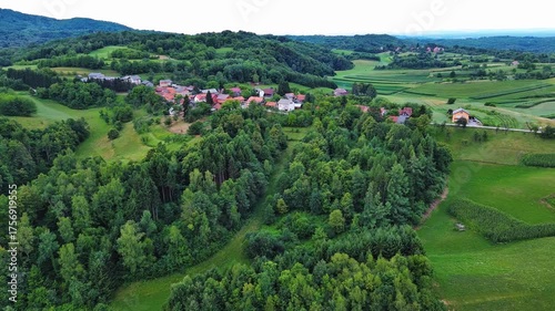 Valley with fields, meadows, agricultural farms, forests and houses