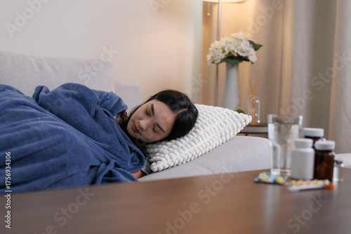 Young woman resting on sofa recovering from illness